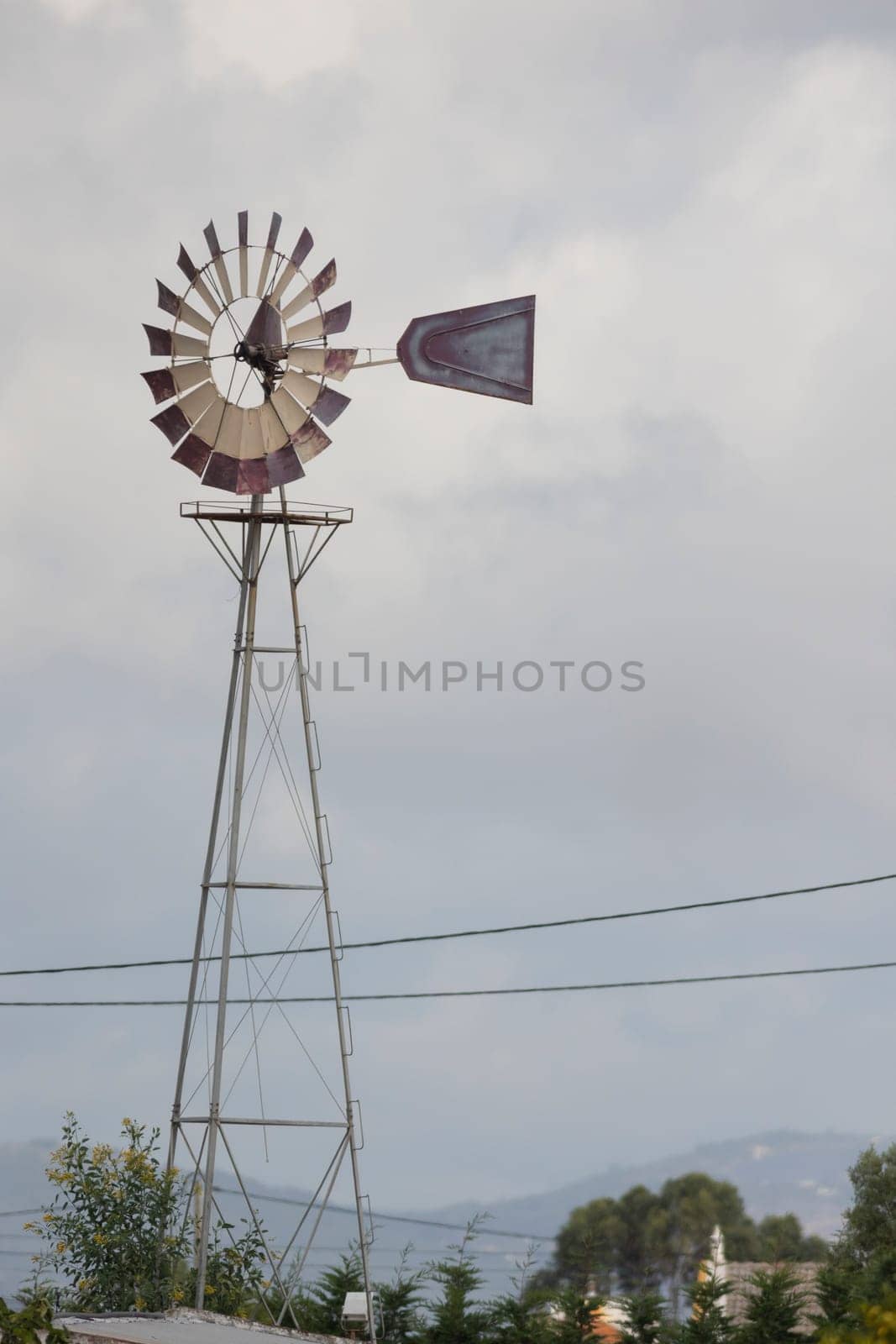 Weather station with anemometer and blue sky in the background, telephoto