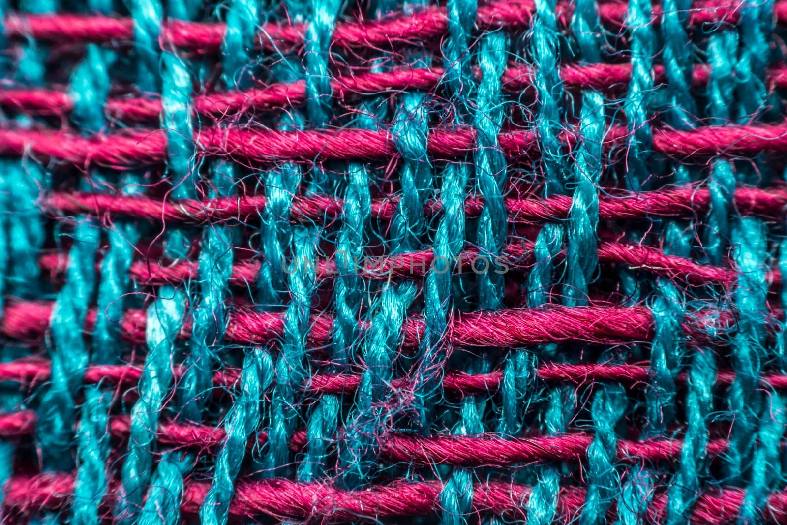 Macro of fabric weave texture surface blue, green and red color use for background