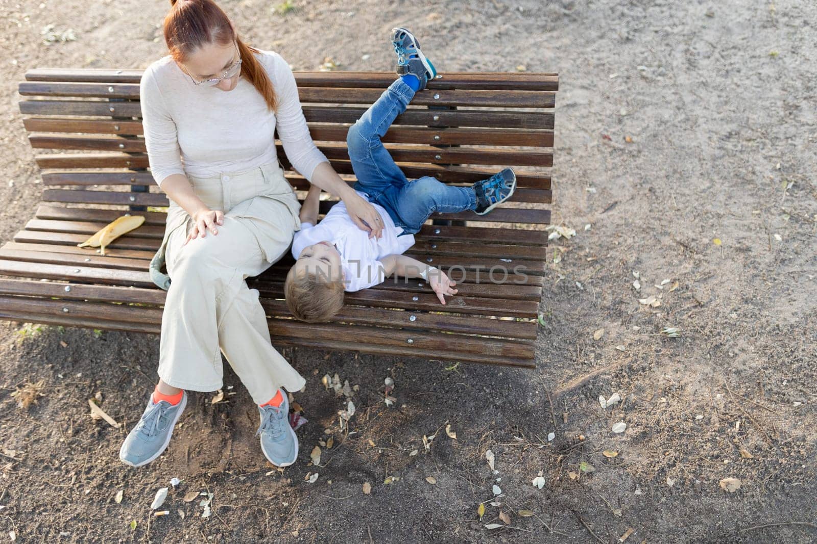 Mother and son relaxing on bench and enjoying time together