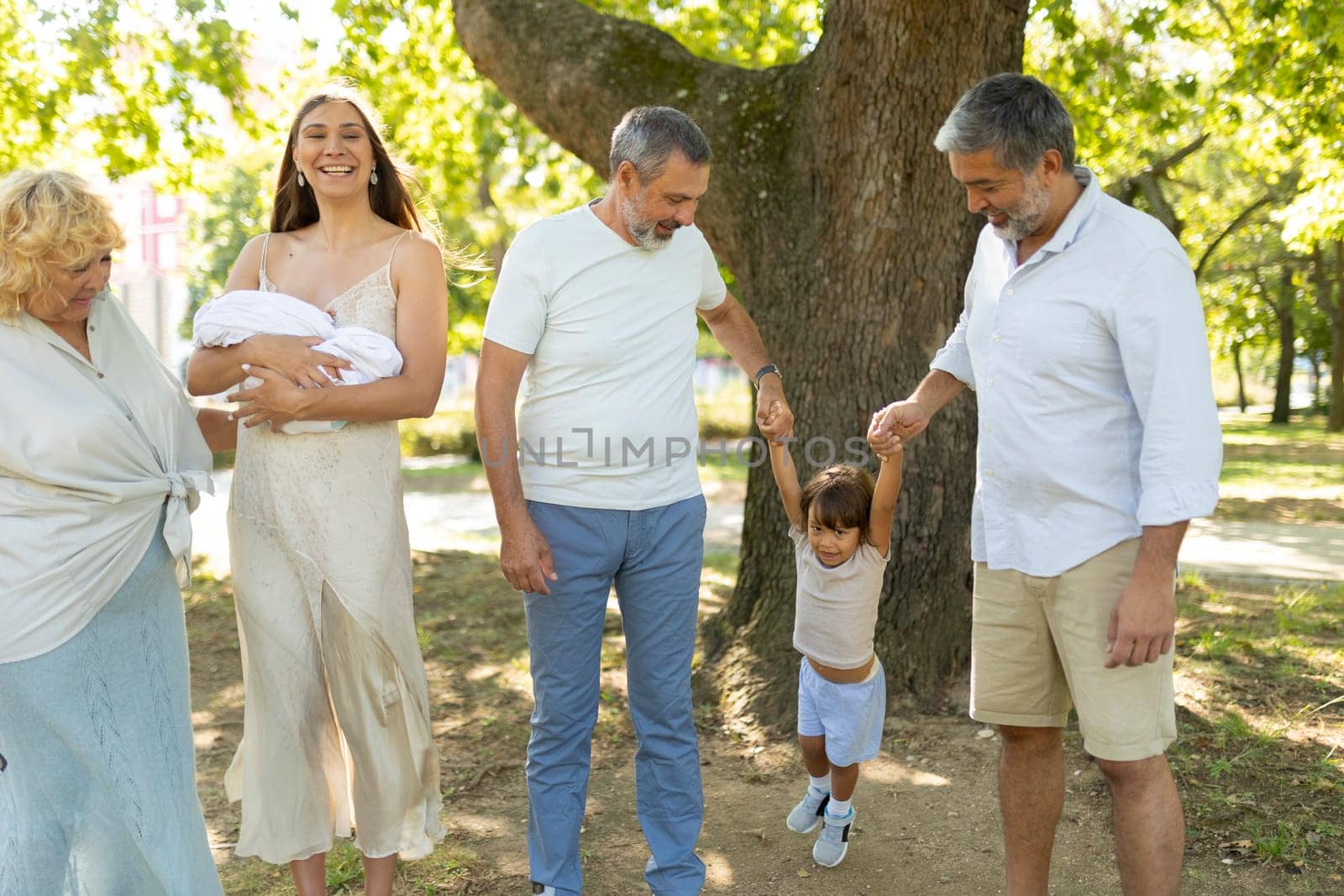 Big family enjoying a sunny day walking in the park