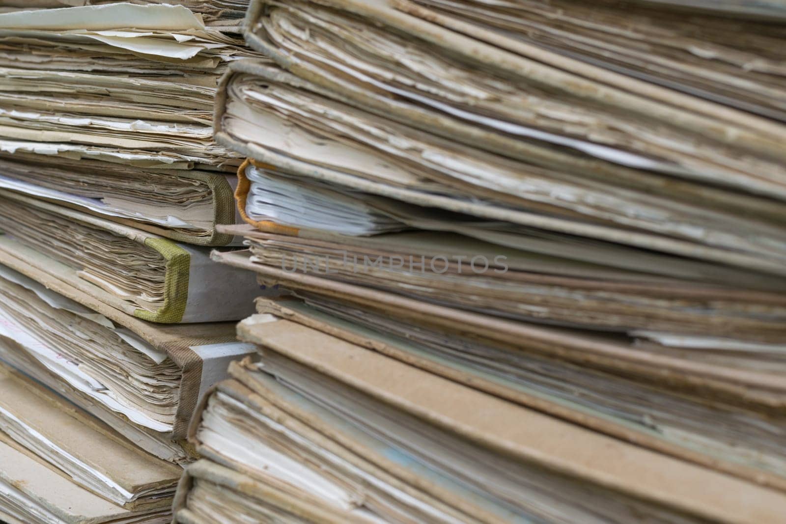 Old files in old folder stacking up in a messy order.
