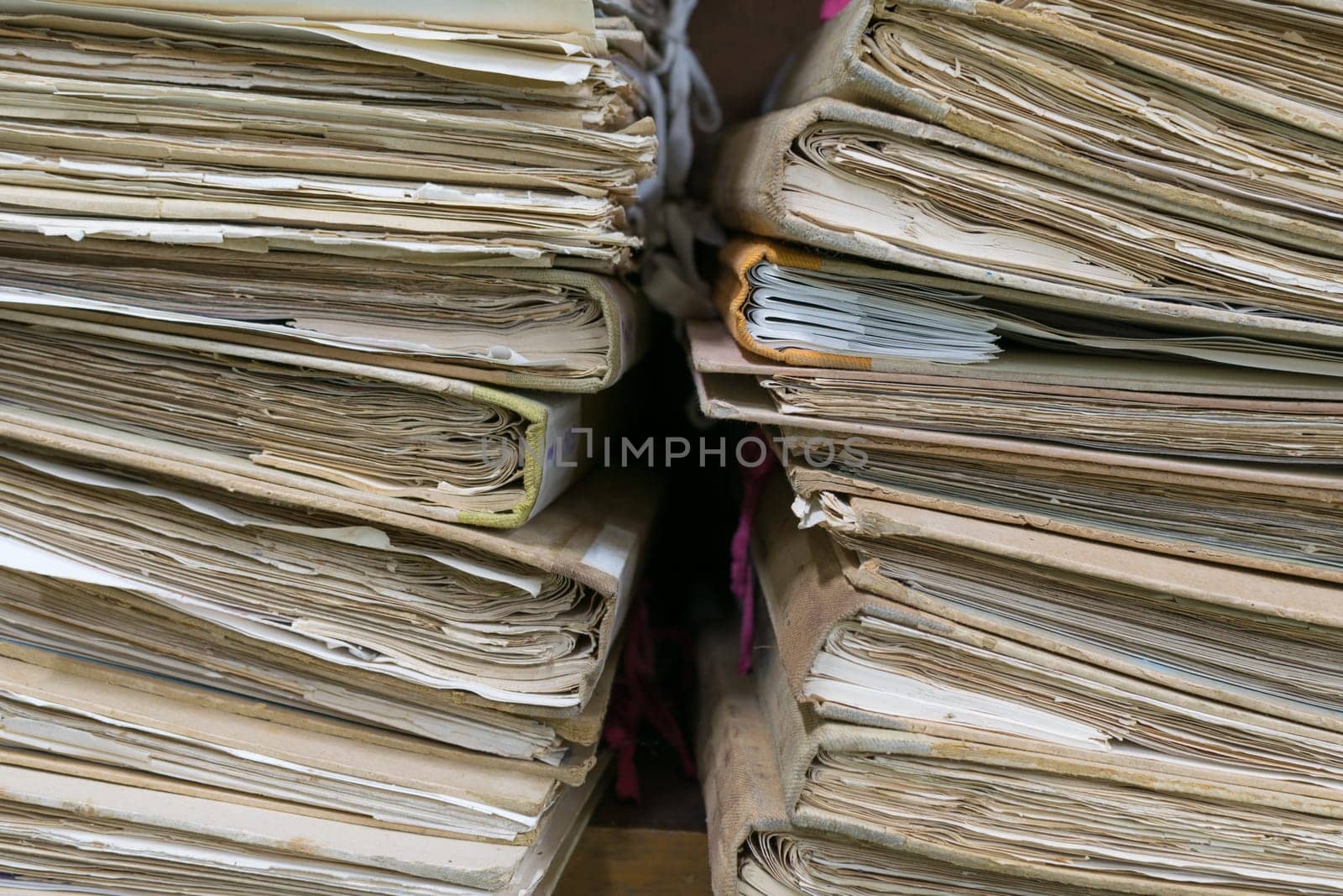 Old files in old folder stacking up in a messy order.