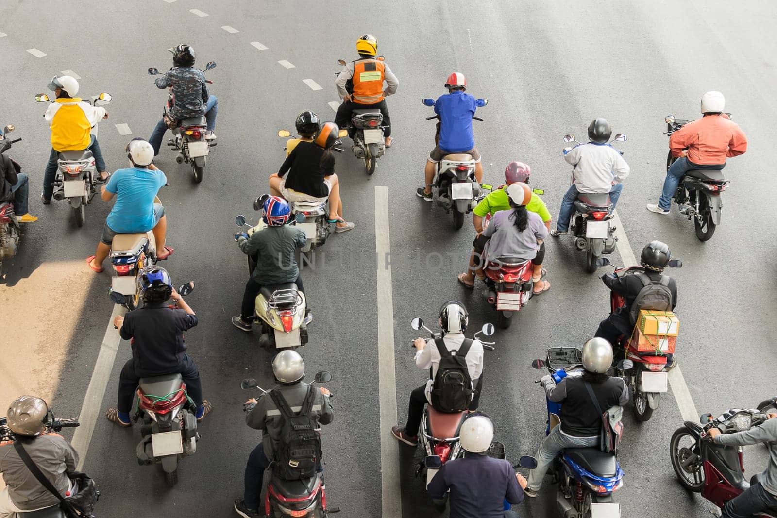 Motorcycle wait to go at intersection with traffic light on a road.