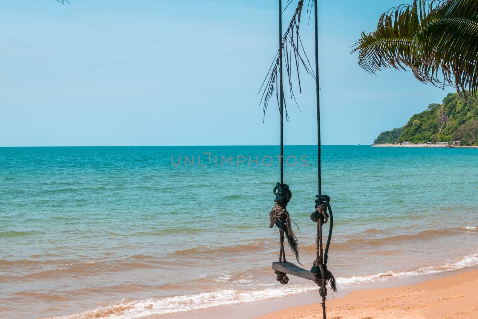 Landscape of travel place with nature at a beach and tropical sea with blue sky and have a outdoor swing use for relax in happy vacation