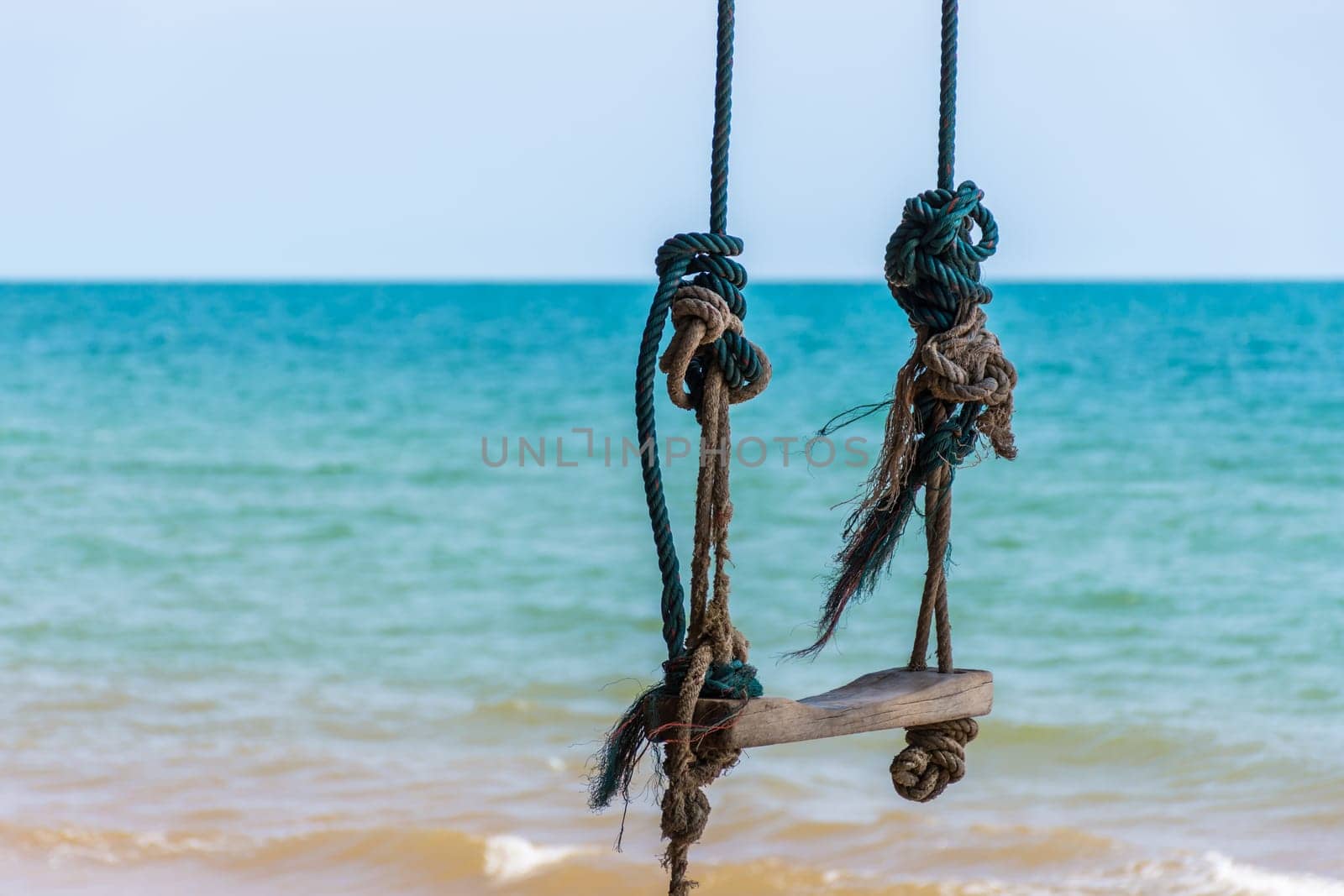 Landscape of travel place with nature at a beach and tropical sea with blue sky and have a outdoor swing use for relax in happy vacation