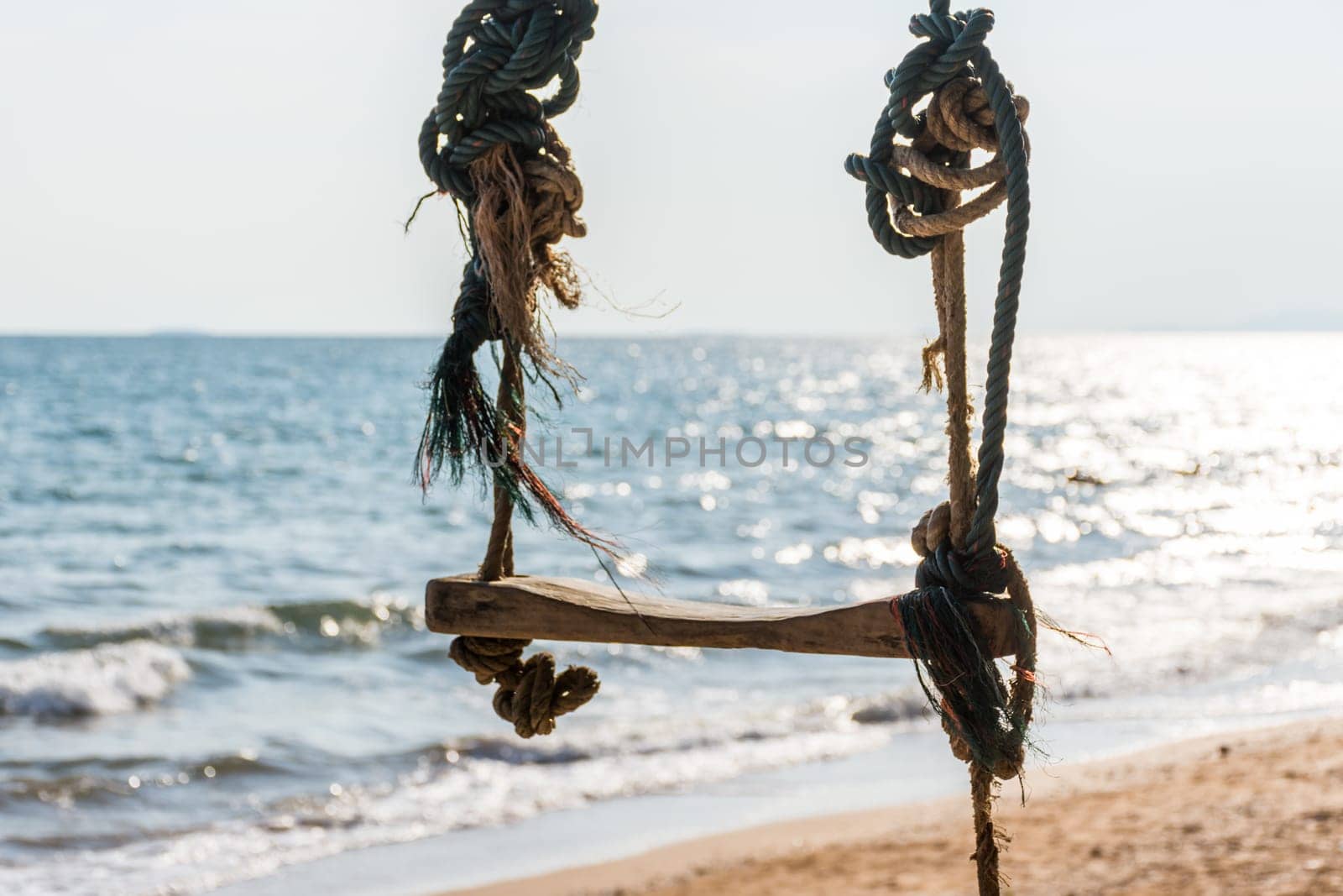 Landscape of travel place with nature at a beach and tropical sea with blue sky and have a outdoor swing use for relax in happy vacation