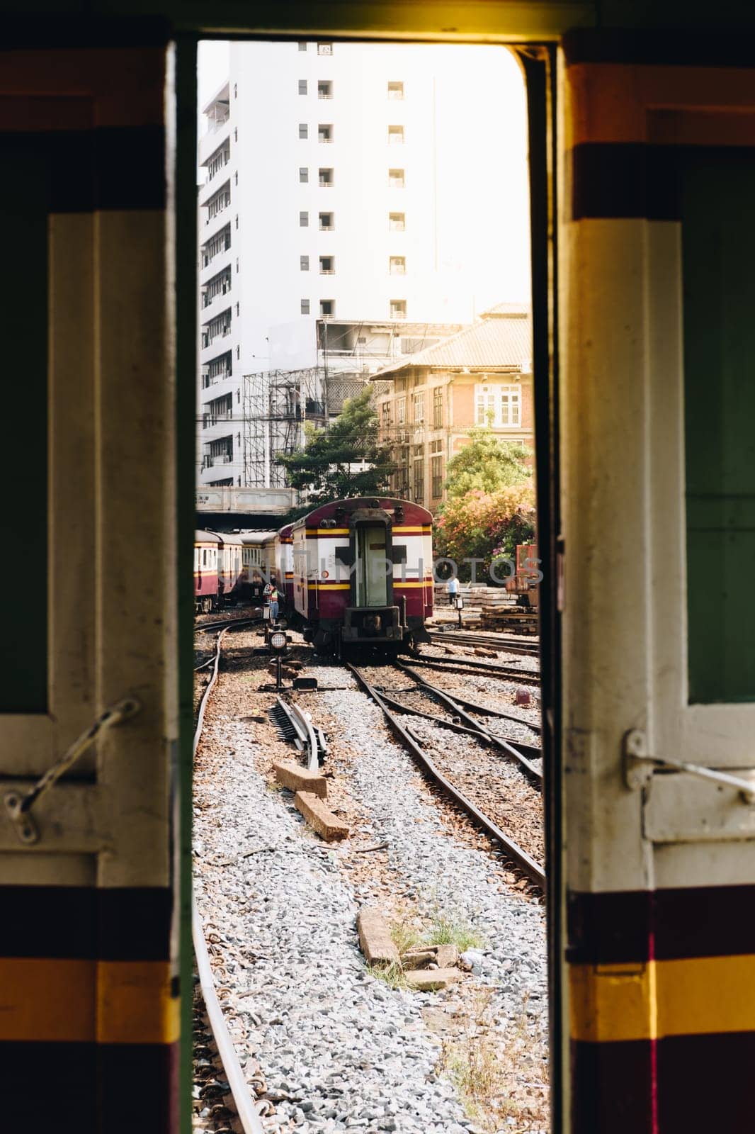 Railway train on the railroad tracks in Bangkok station. Many people in Thailand popular travel by train because it is cheaper.