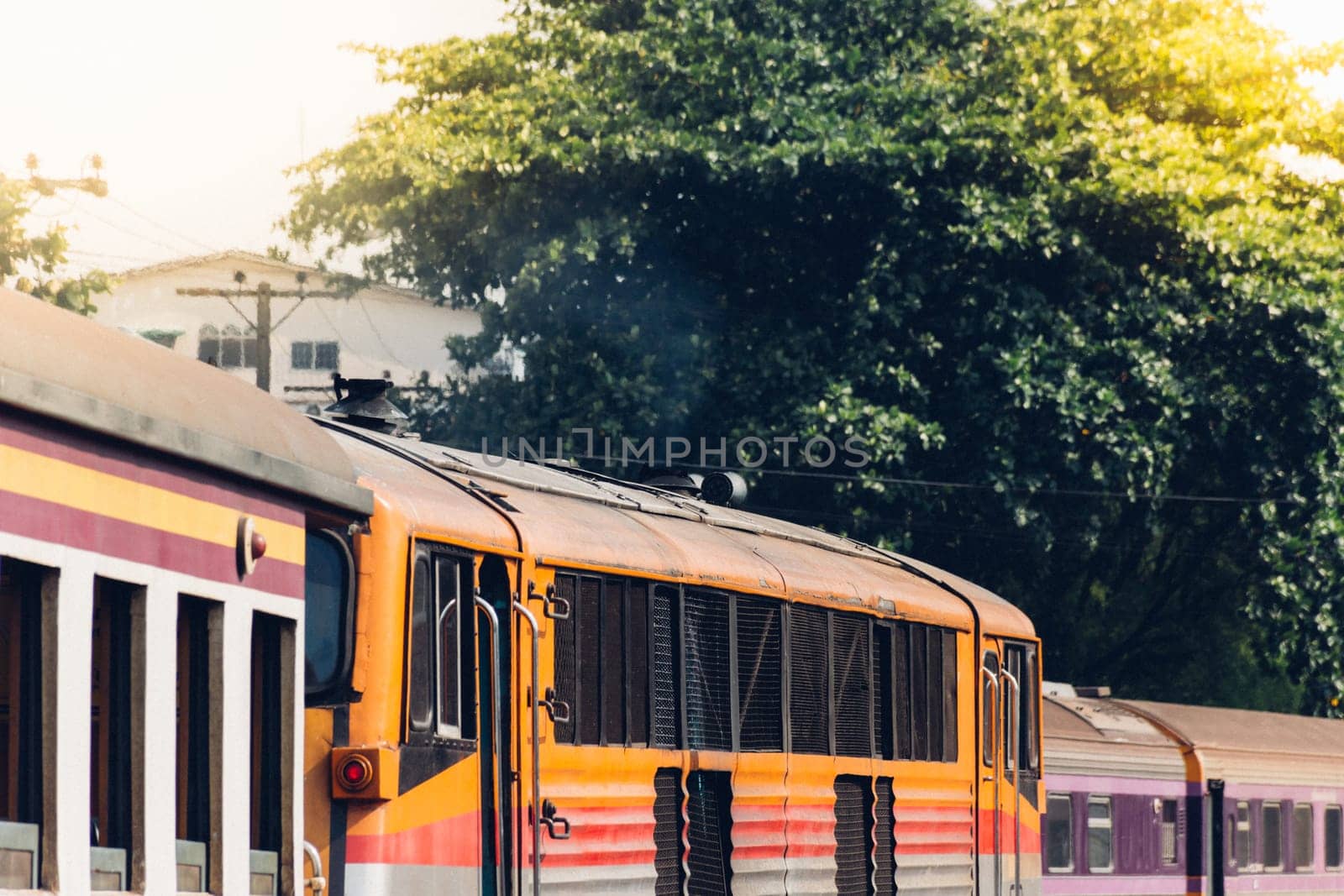 Railway train on the railroad tracks in Bangkok station. Many people in Thailand popular travel by train because it is cheaper.