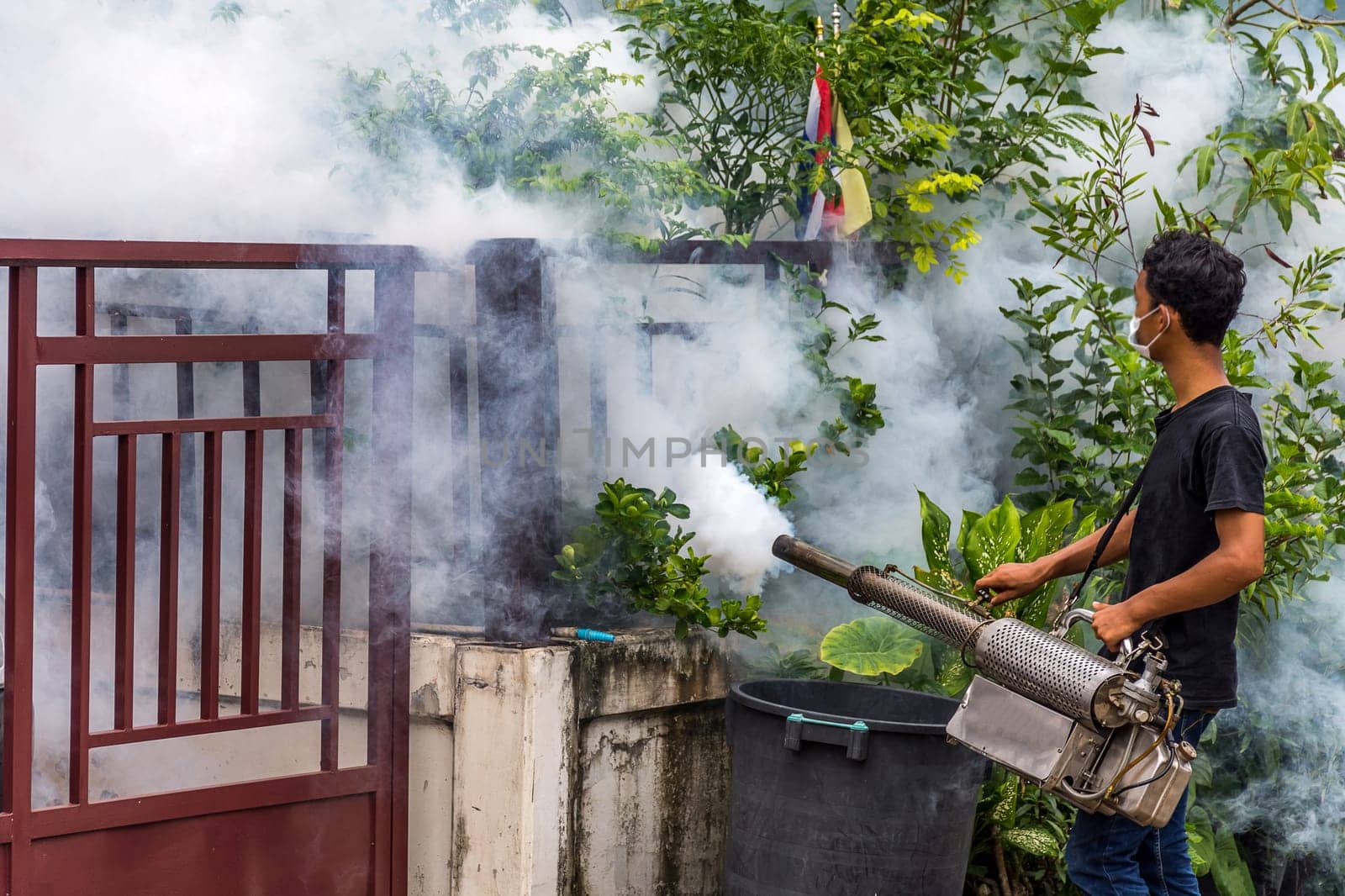 People fogging DDT spray kill mosquito for control Malaria, Encephalitis, Dengue and Zika in village at Bangkok Thailand.