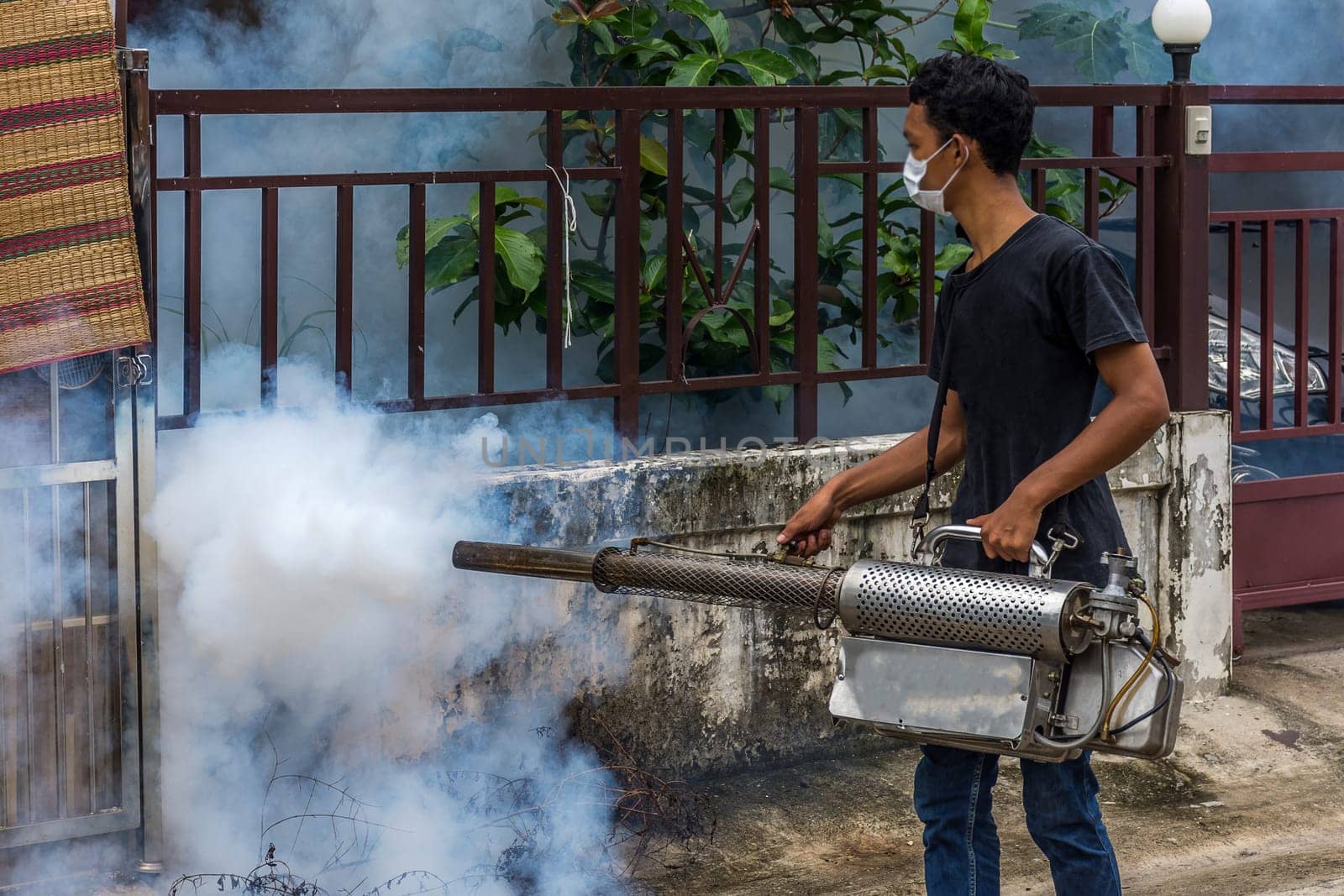 People fogging DDT spray kill mosquito for control Malaria, Encephalitis, Dengue and Zika in village at Bangkok Thailand.