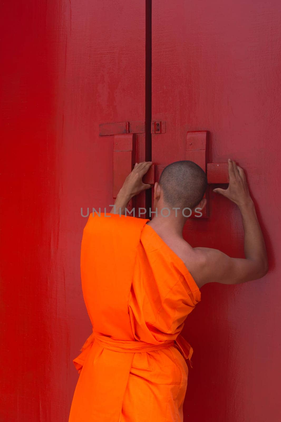 Thai monk and buddhist temple gate is a wooden door red color vintage style