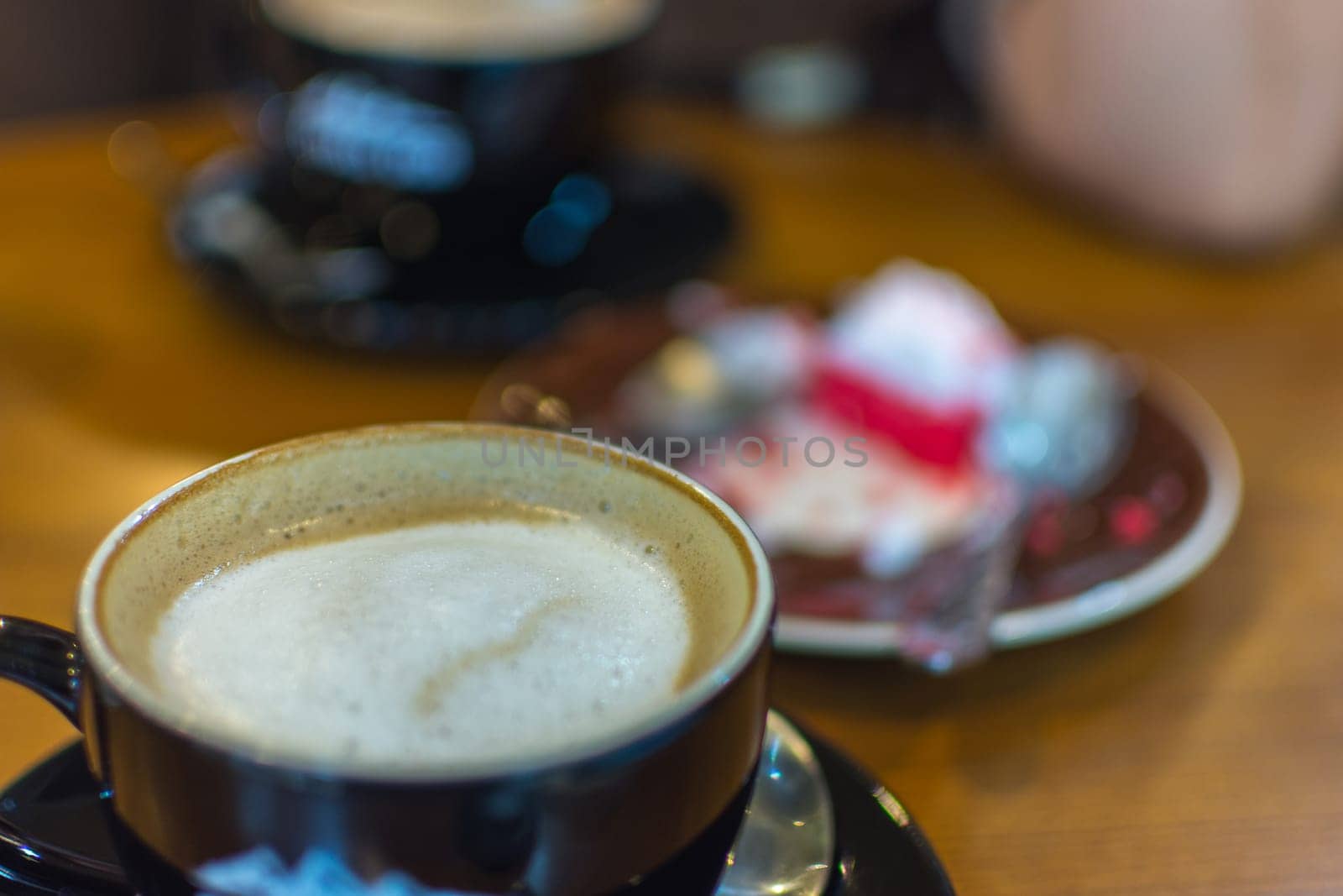 Hot Coffee in black cup on wood table