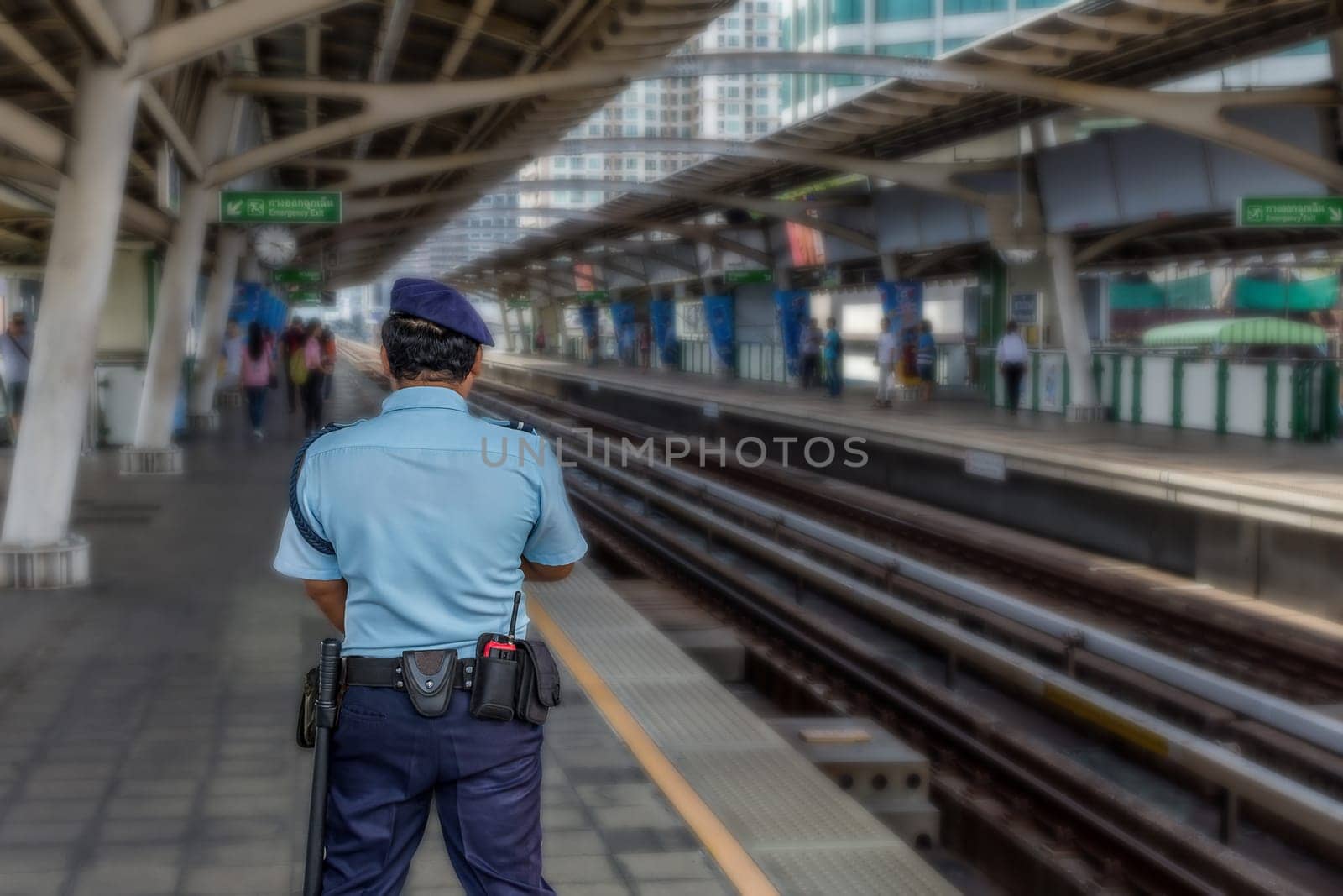 Security guard on BTS skytrain train runs in Bangkok. Many people in Bangkok used skytrain to save time.