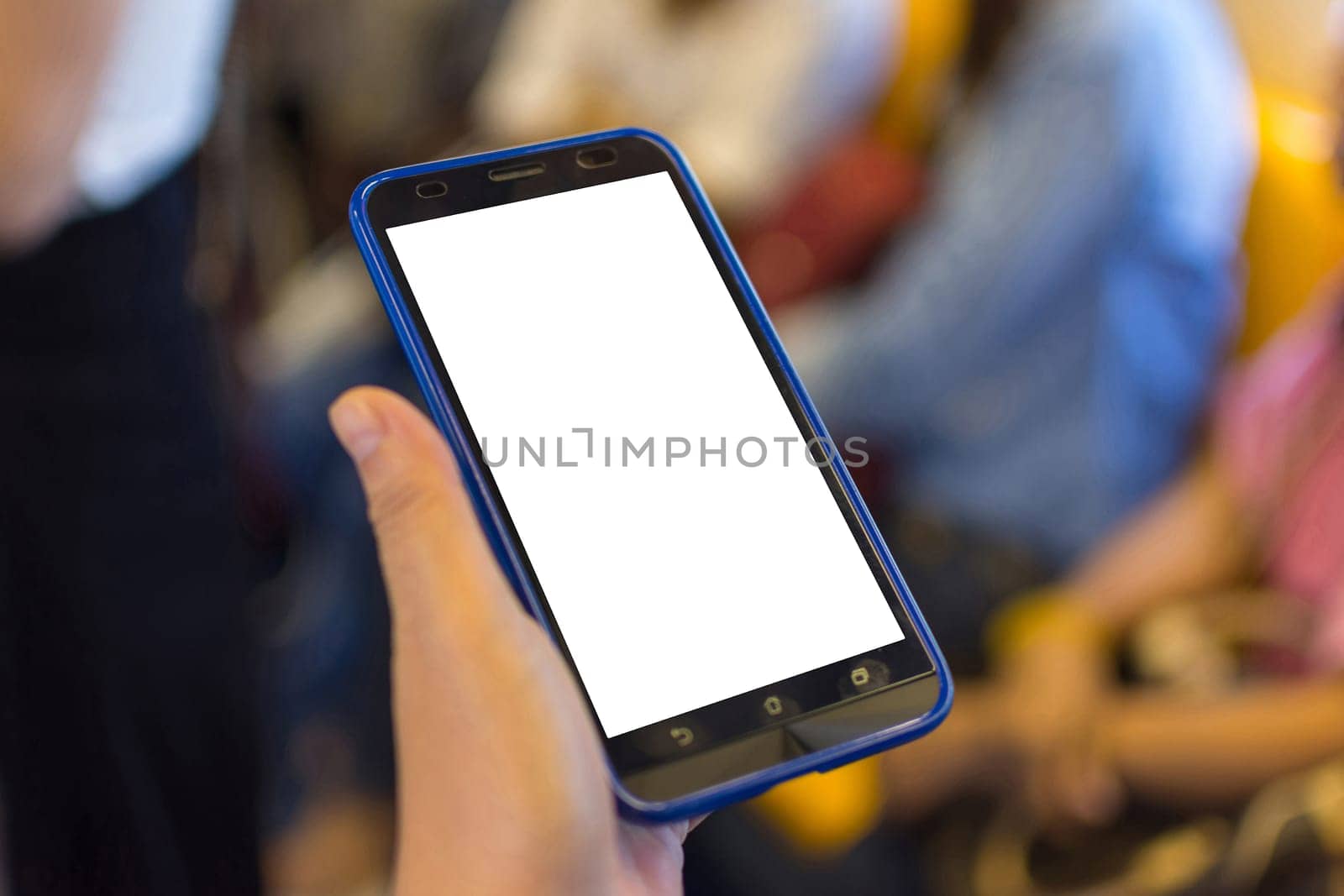 Person hand holding smartphone or mobile phone with white screen using in skytrain for checking