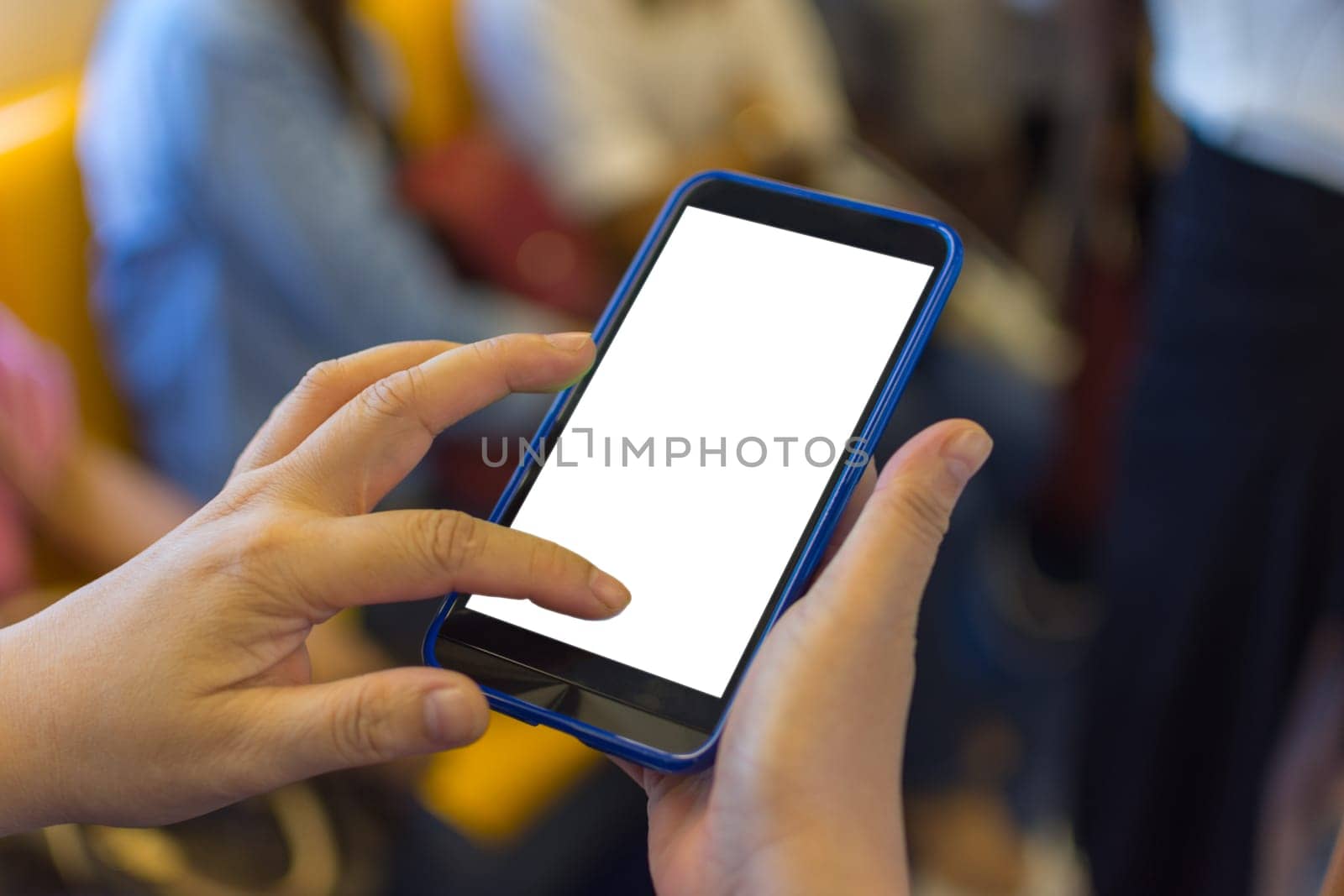 Person hand holding smartphone or mobile phone with white screen using in skytrain for checking