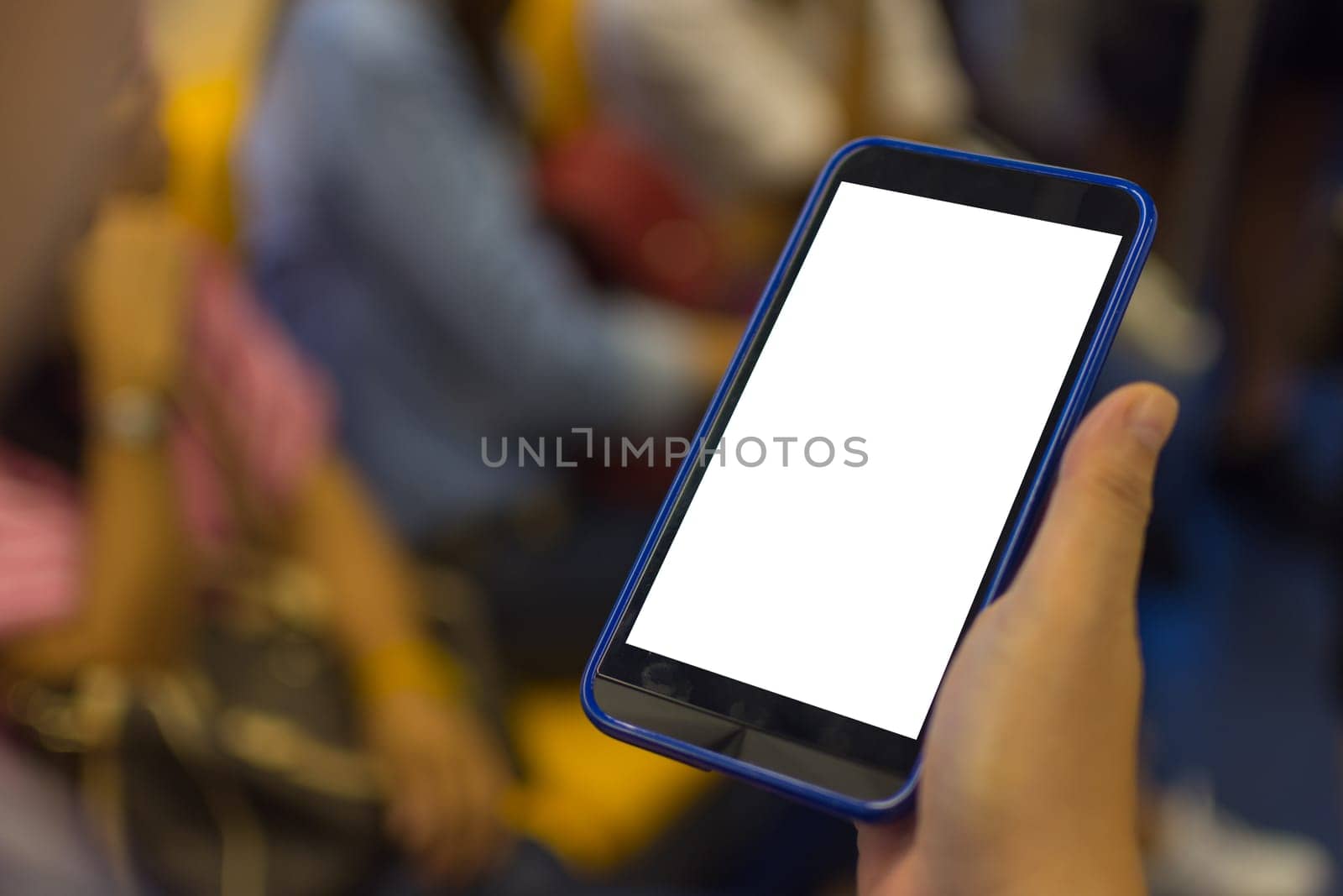 Person hand holding smartphone or mobile phone with white screen using in skytrain for checking