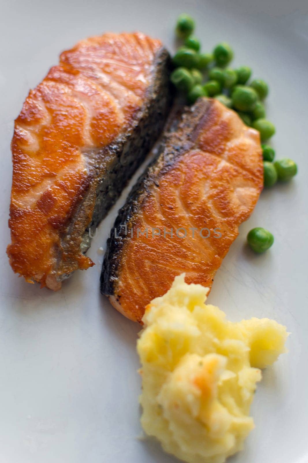 Steak salmon fish on white dish at Thai hotel