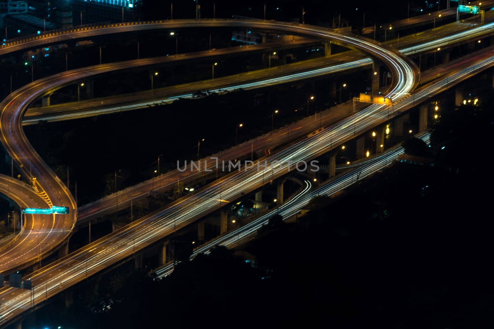 Cityscape, Expressway with light of car on road and Bangkok city with building and transportation in nighttime from Skyscraper by long exposure photography