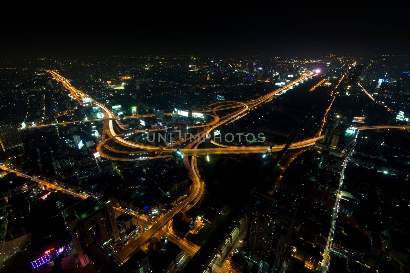 Cityscape, Expressway with light of car on road and Bangkok city with building and transportation in nighttime from Skyscraper by long exposure photography