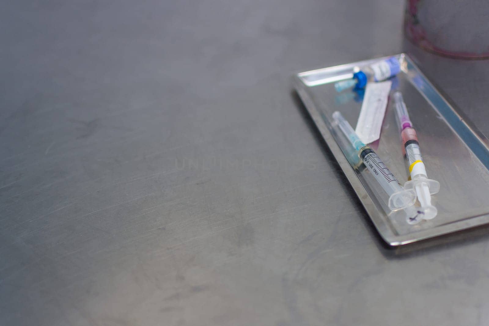 Syringe with needle on a steel tray for a medical vaccine in a hospital