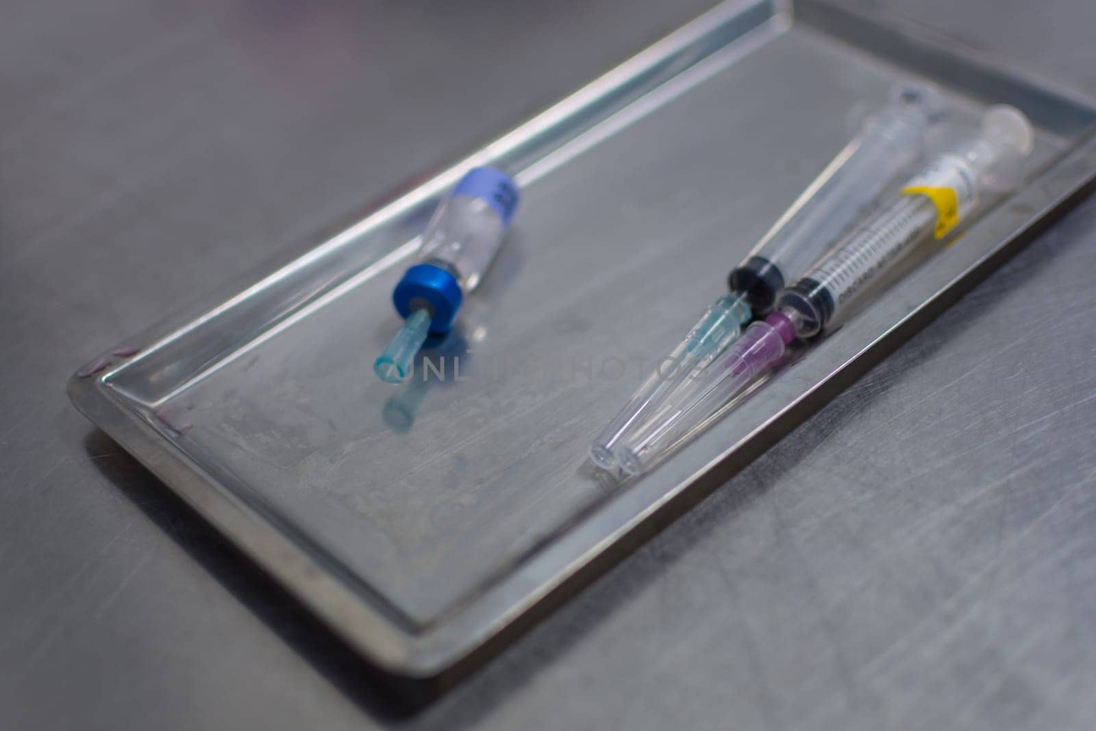 Syringe with needle on a steel tray for a medical vaccine in a hospital
