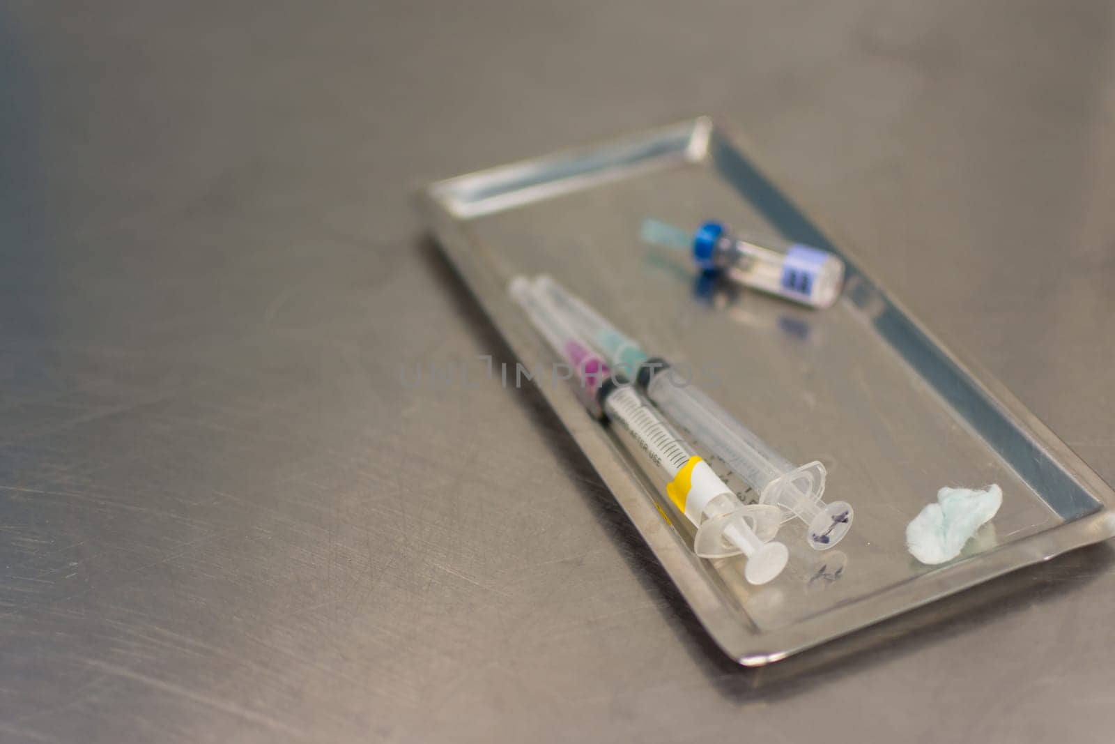 Syringe with needle on a steel tray for a medical vaccine in a hospital