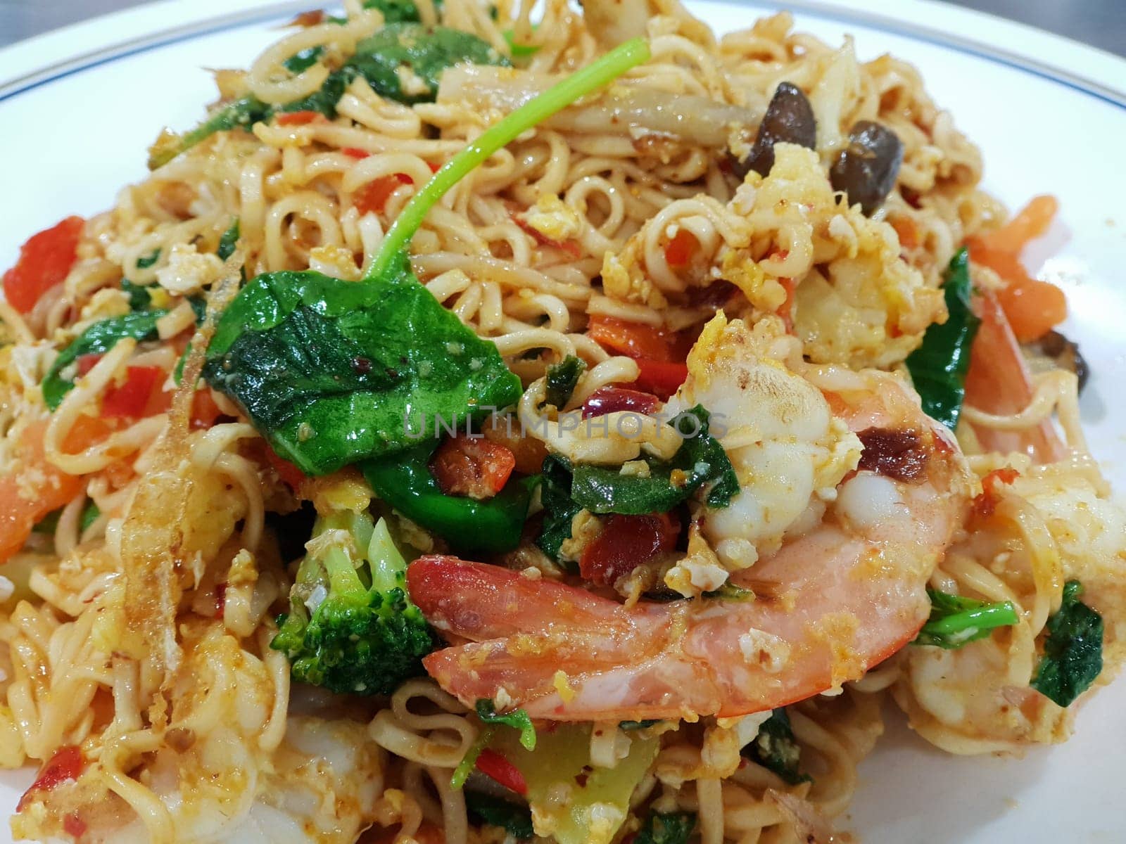 Instant noodle mama drunken fried shrimp for sale at Thai street food market or restaurant in Thailand