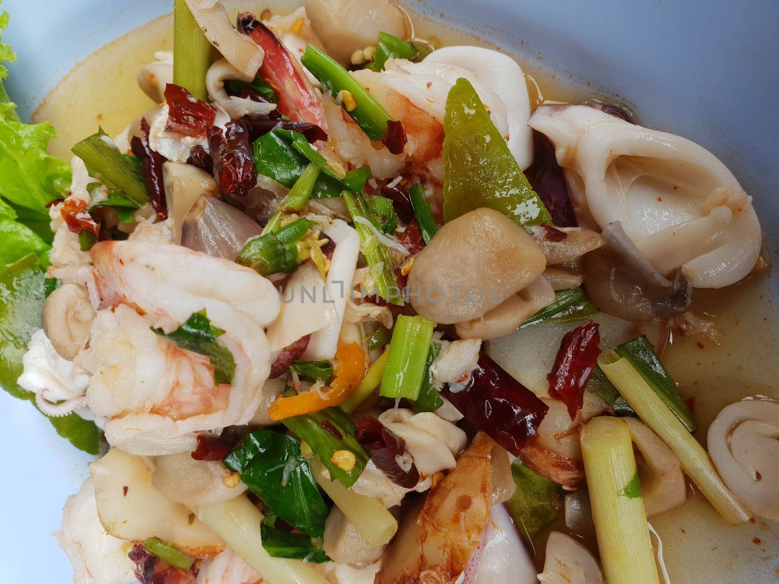 Dry fried hot and sour seafood soup (Dry Tom Yum) for sale at Thai street food market or restaurant in Thailand