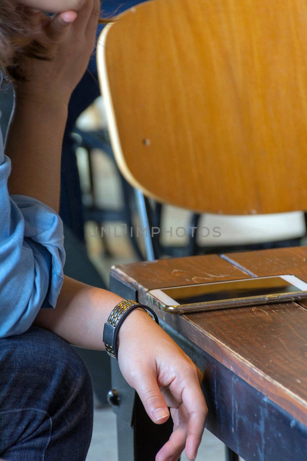 Mobile phone and women on wood table in coffee shop or restaurant