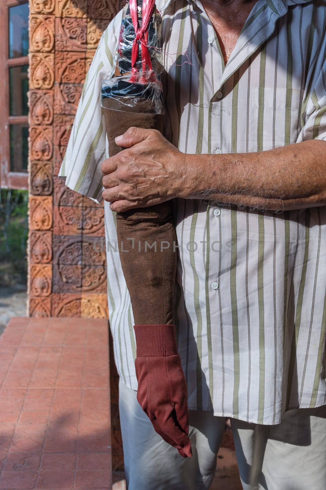Asia elderly man have tanned skin disabled with one arm and arm prosthetic because accident