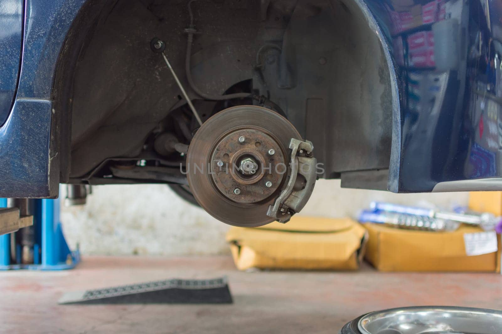 Checking car brake and  suspension system in a car for repair at garage