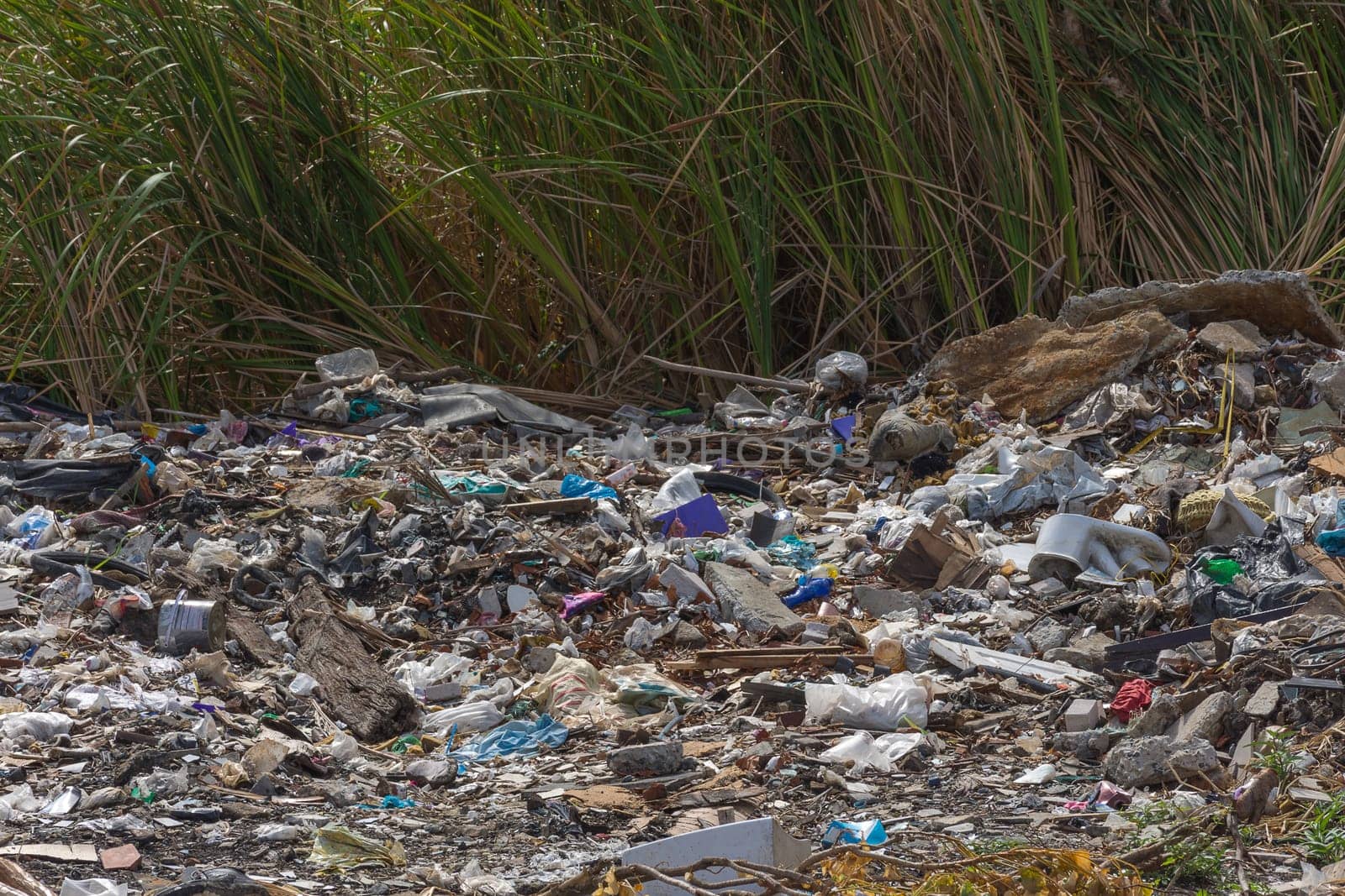 Garbage and junk dump to the landfill in field it illegal, hazardous and dangerous for environment