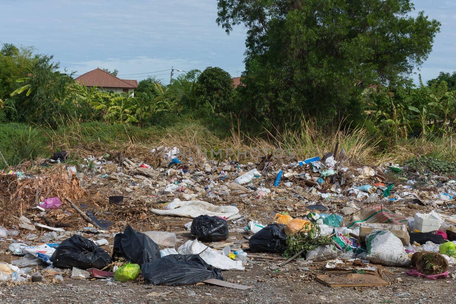 Garbage and junk dump to the landfill in field it illegal, hazardous and dangerous for environment
