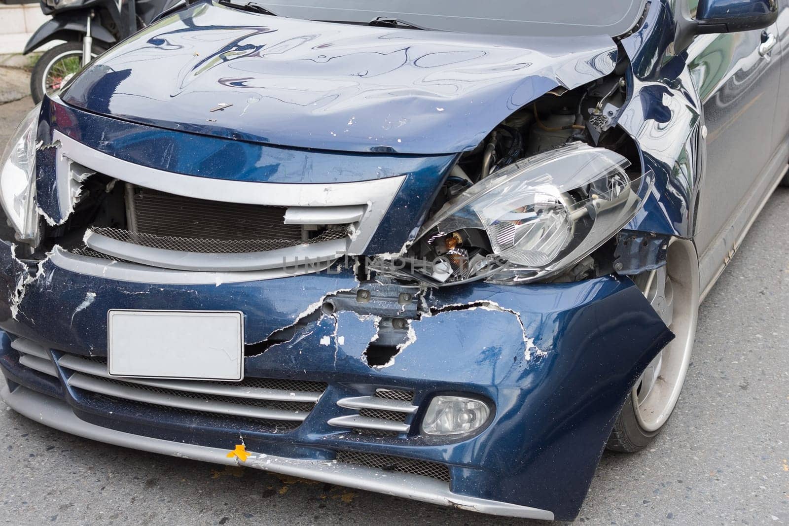 Car crash from car accident on the road in a city between saloon versus pickup wait insurance.