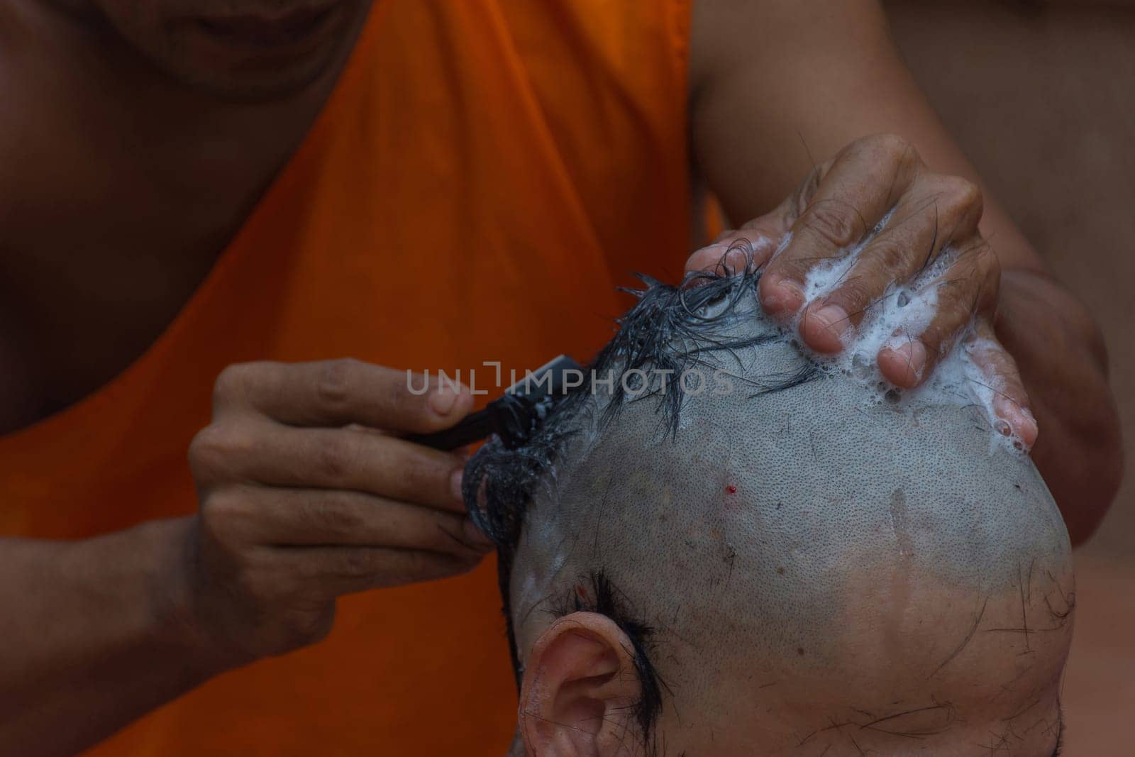 Thai monk hair shave a man for ordination ceremony in buddhist in Thailand