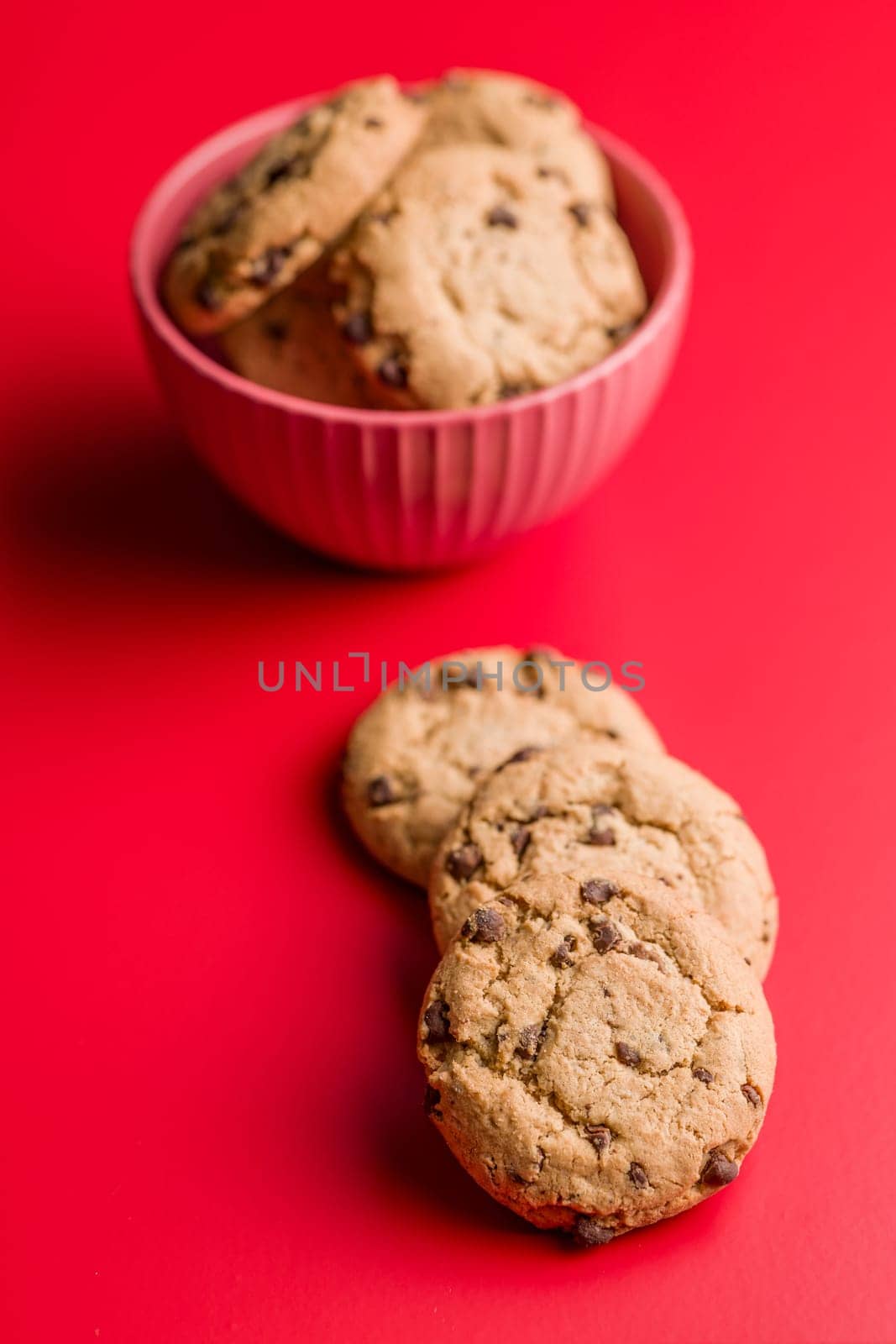 Chocolate chip cookies on a red background.