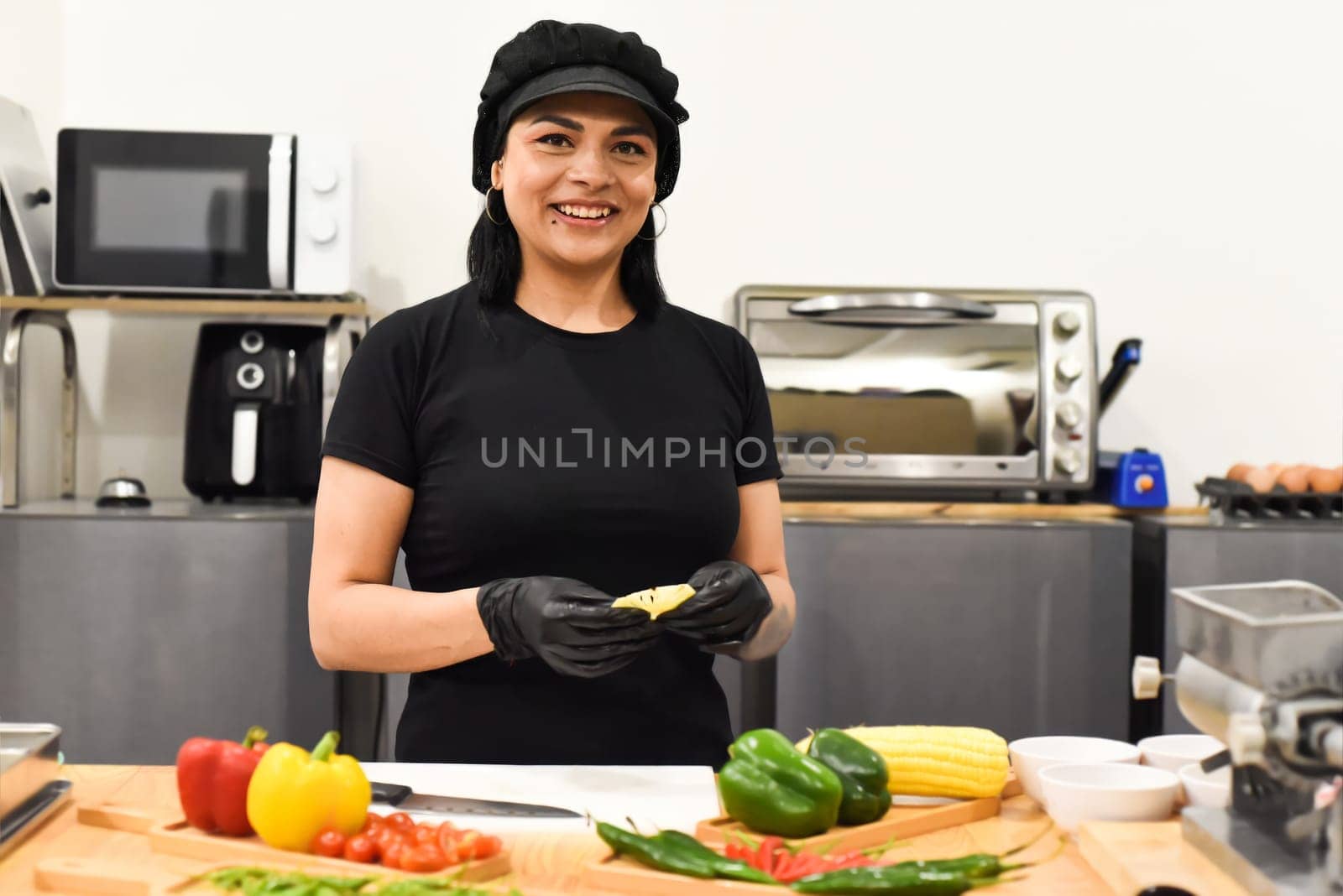 Mexican woman laughing during cooking tacos in the kitchen