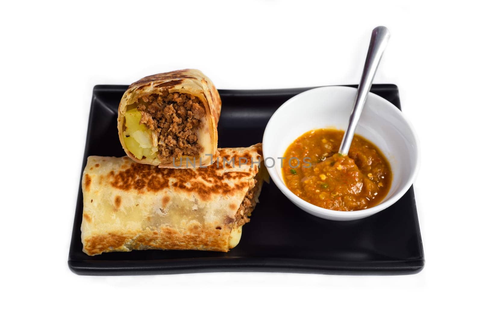 Mexican burrito with pork, cheese, potato served with sauce borracha