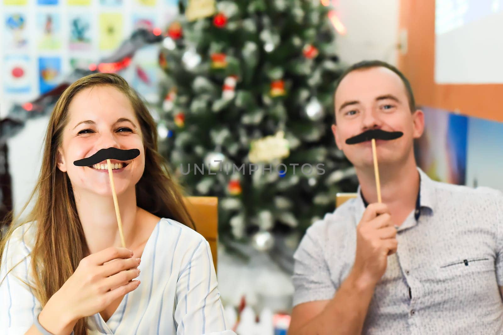 Two friends Russian and Slovak having fun in against chistamas tree at home