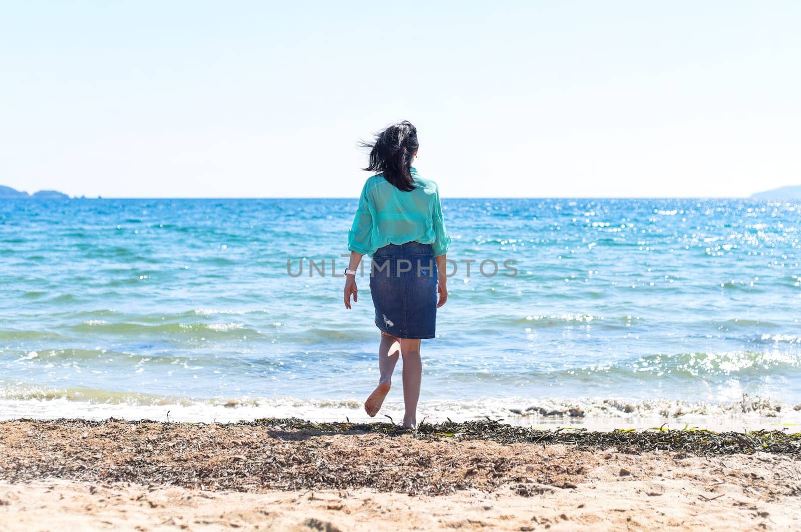 Office worker running to the sea after work. freedom concept