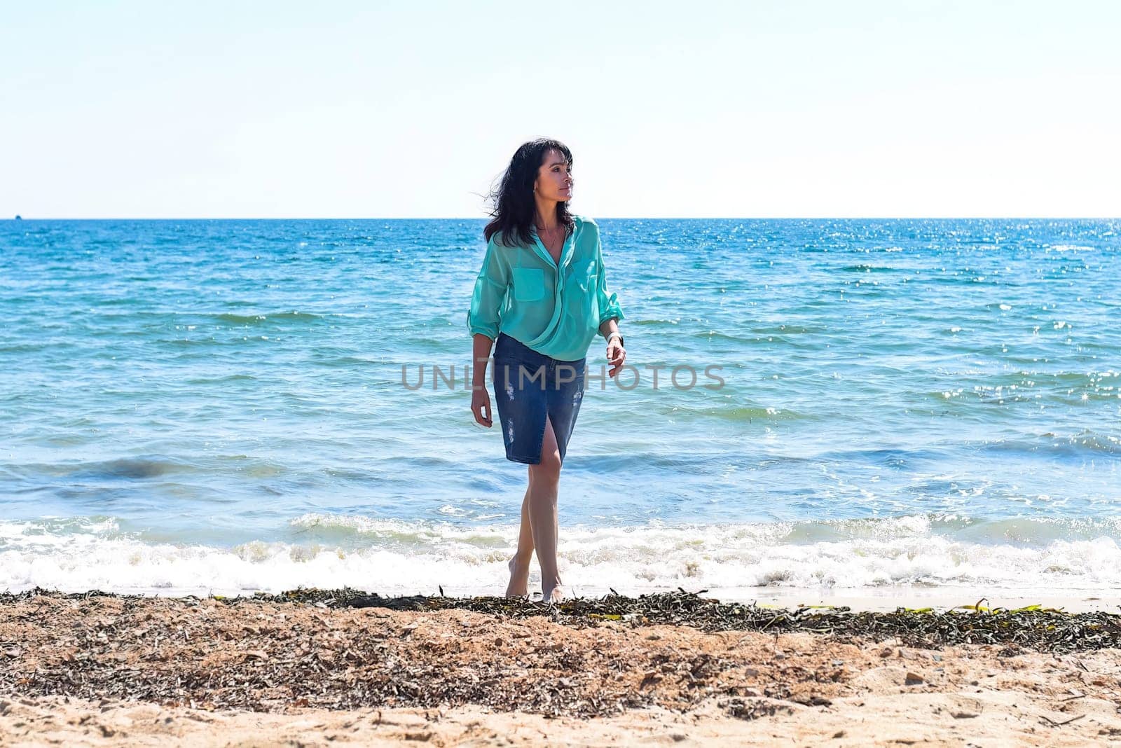 45 years old Russian woman standing in Japanese sea and looking away