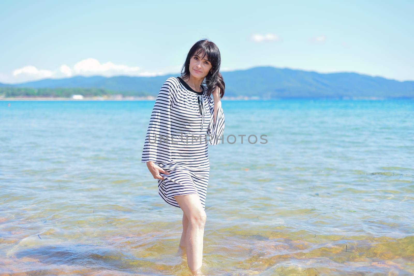 45 years old Russian woman laughing and standing in Japanese sea