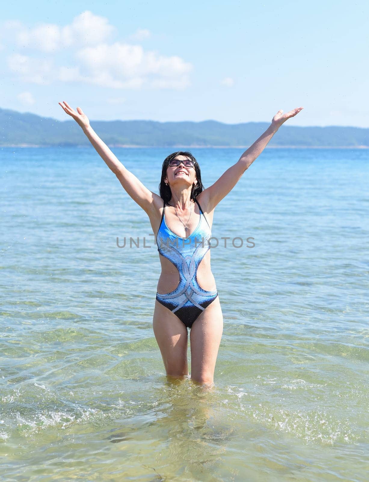 45 years old Russian woman in swimsuit laughing and standing in Japanese sea