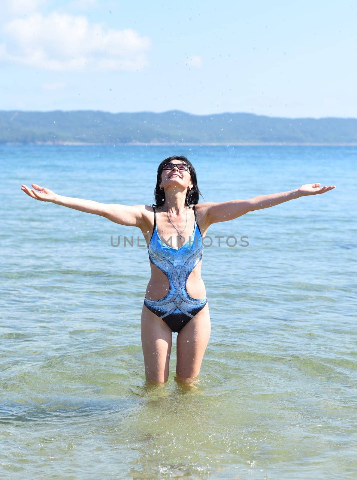 45 years old Russian woman in swimsuit laughing and standing in Japanese sea