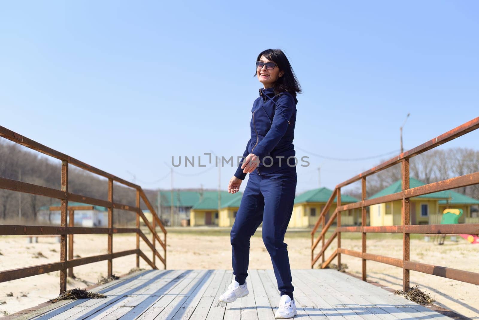 Cheerful 45 y.o. Russian woman running towards the camera and laughingCheerful 45 y.o. Russian woman running towards the camera and laughing