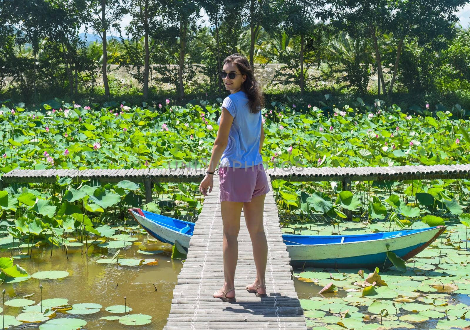 Young woman against Lotus lake in Vietnam