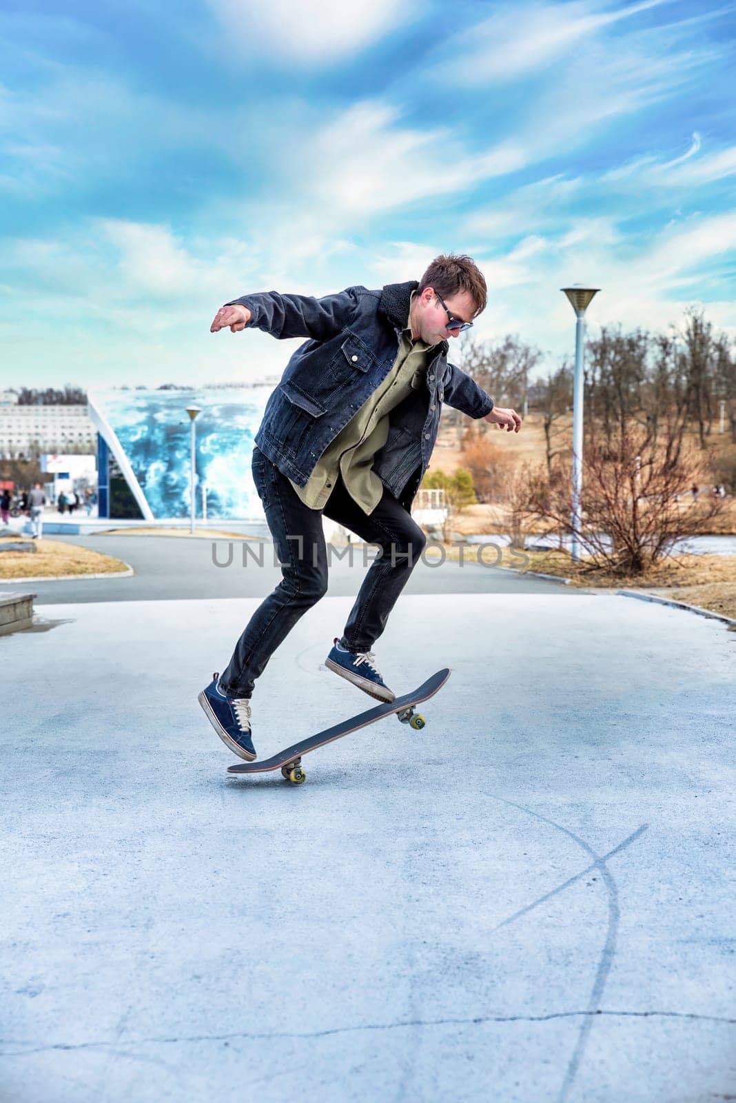 Young man riding a skateboard making tricks and jumps