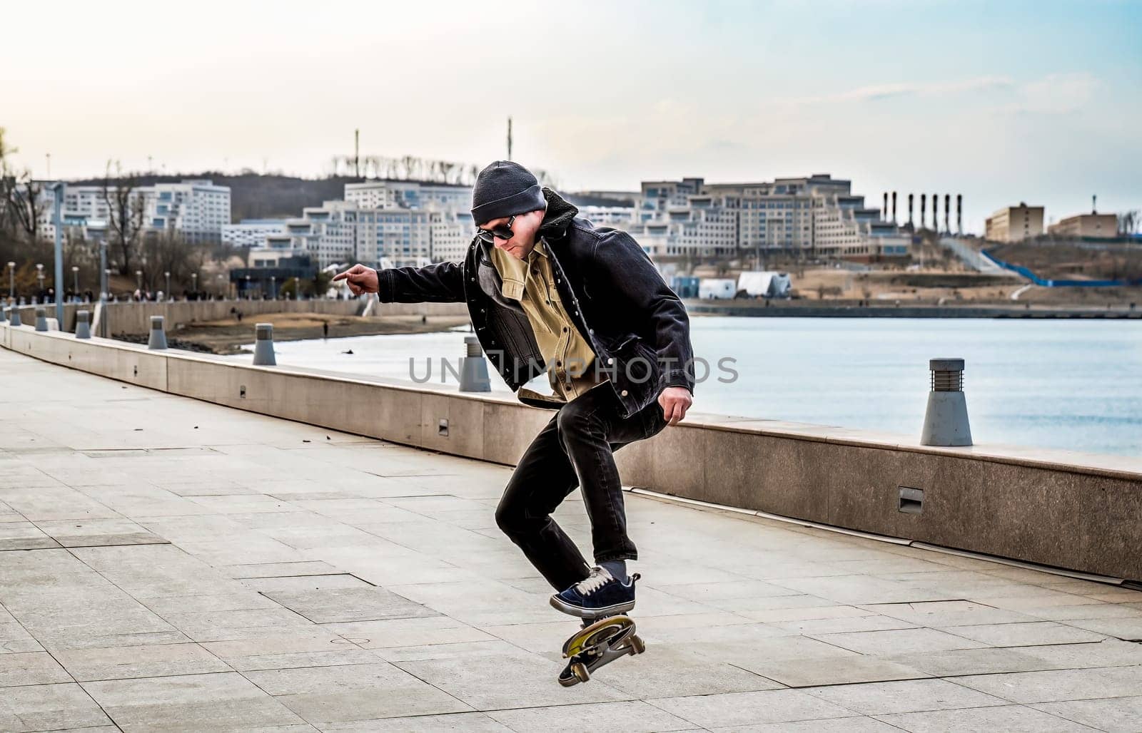 Young man riding a skateboard making tricks and jumps