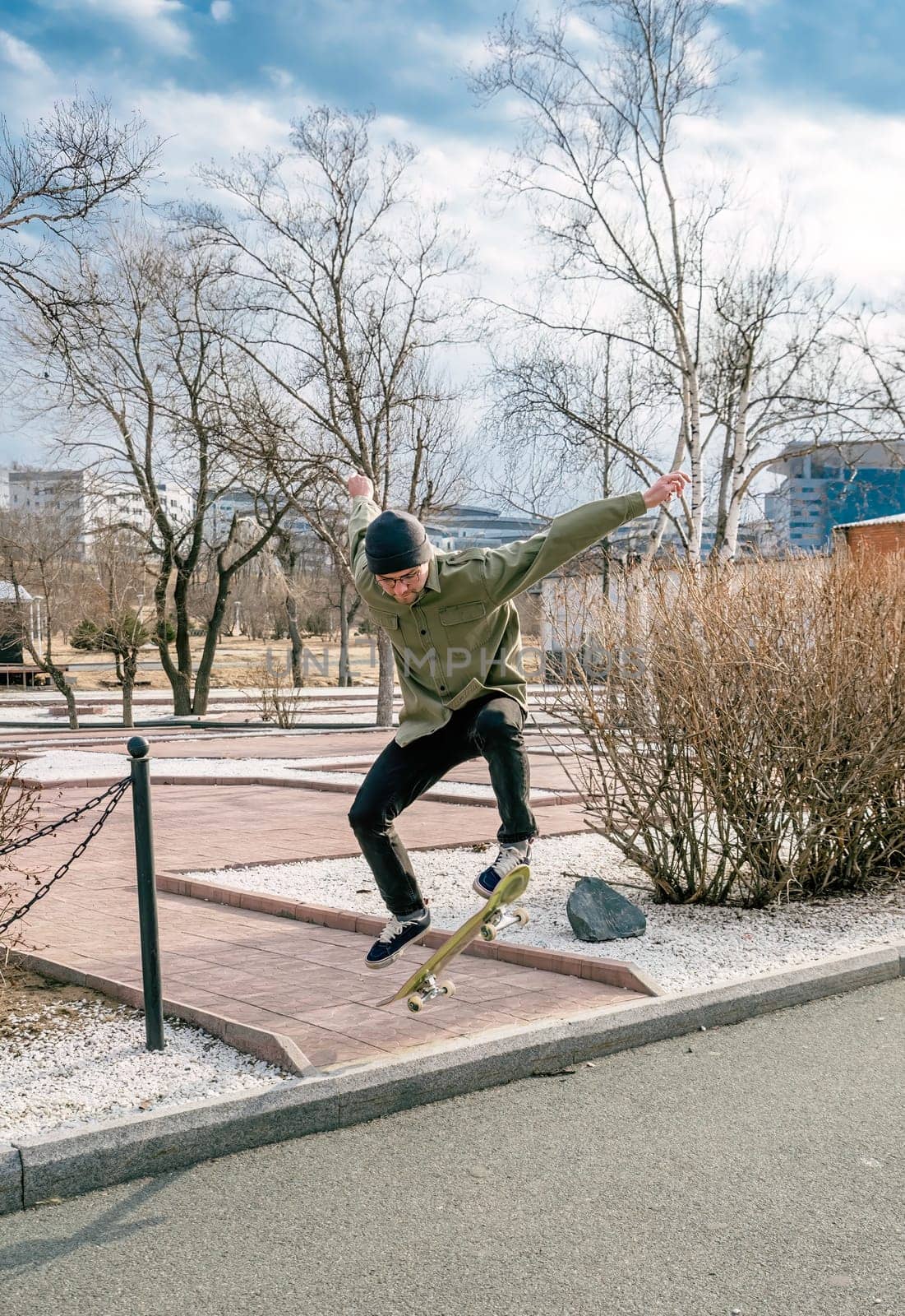 Young man riding a skateboard making tricks and jumps
