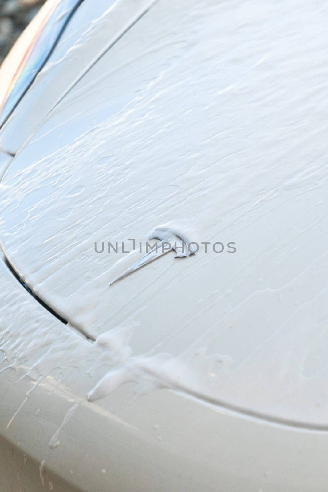 Denver, Colorado, USA-September 1, 2023-Efficiently cleaning an electric car in the comfort of a suburban driveway, combining eco-consciousness with practicality.